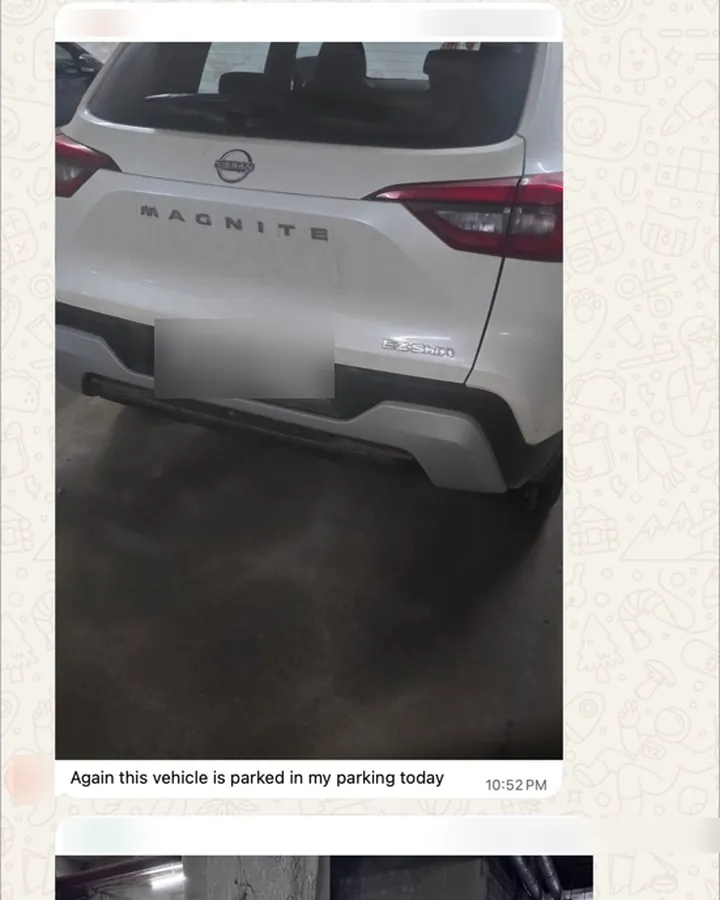 WhatsApp message with a photo of a white SUV parked in the sender's spot again