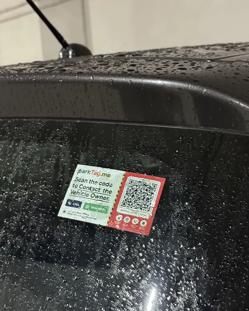 ParkTag on a rear windscreen covered in raindrops