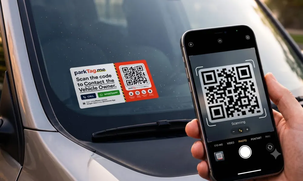 ParkTag sticker on car windshield being scanned by phone